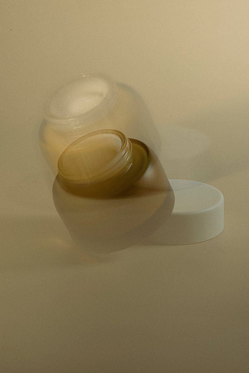 Blurry Cosmetic Jar on Brown Background